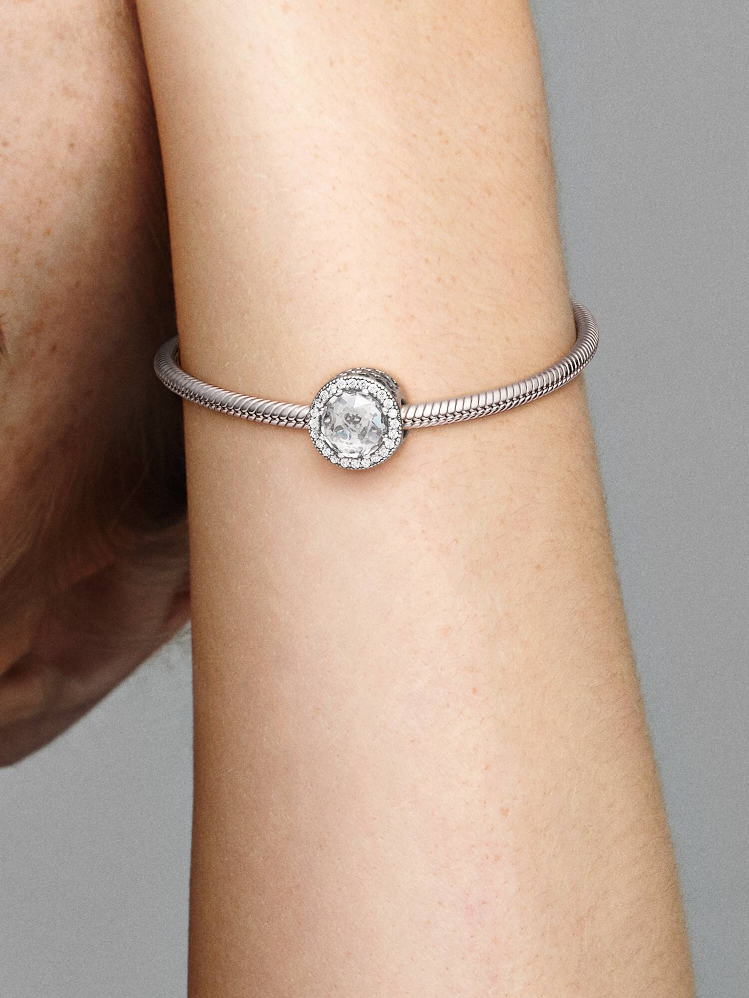 Abstract silver charm with clear cubic zirconia