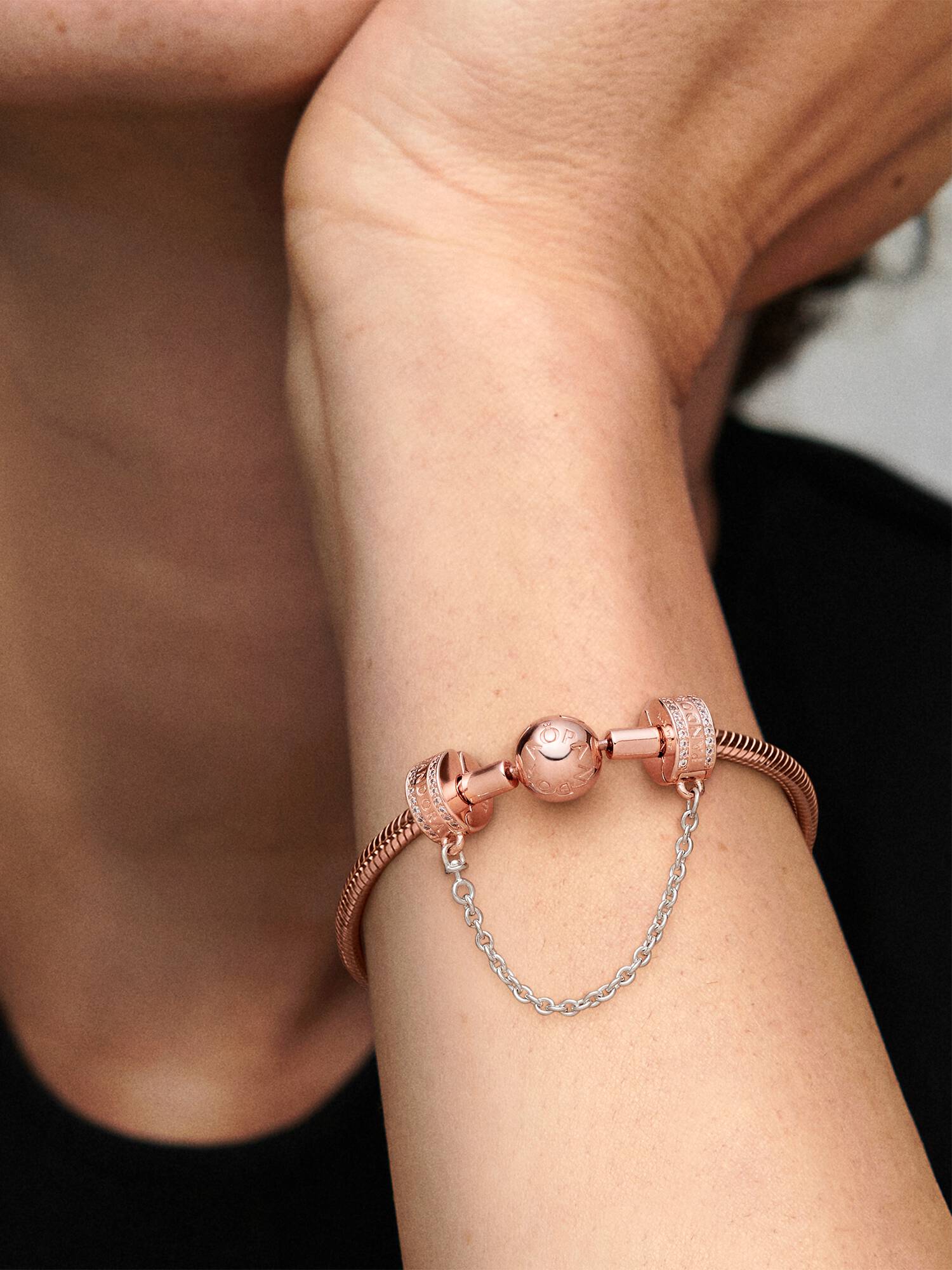 14k Rose gold-plated logo safety chain with clear cubic zirconia, silicone grip and silver chain