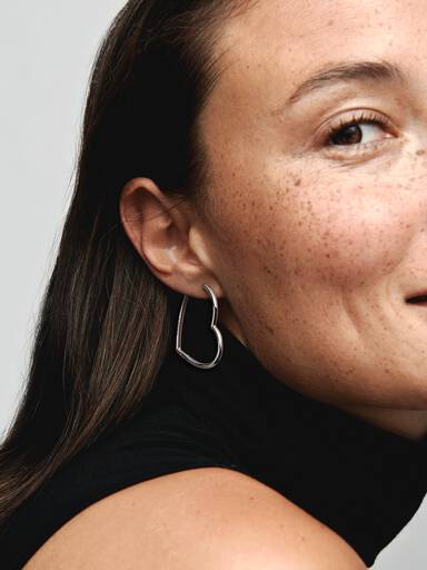Asymmetrical heart silver hoop earrings