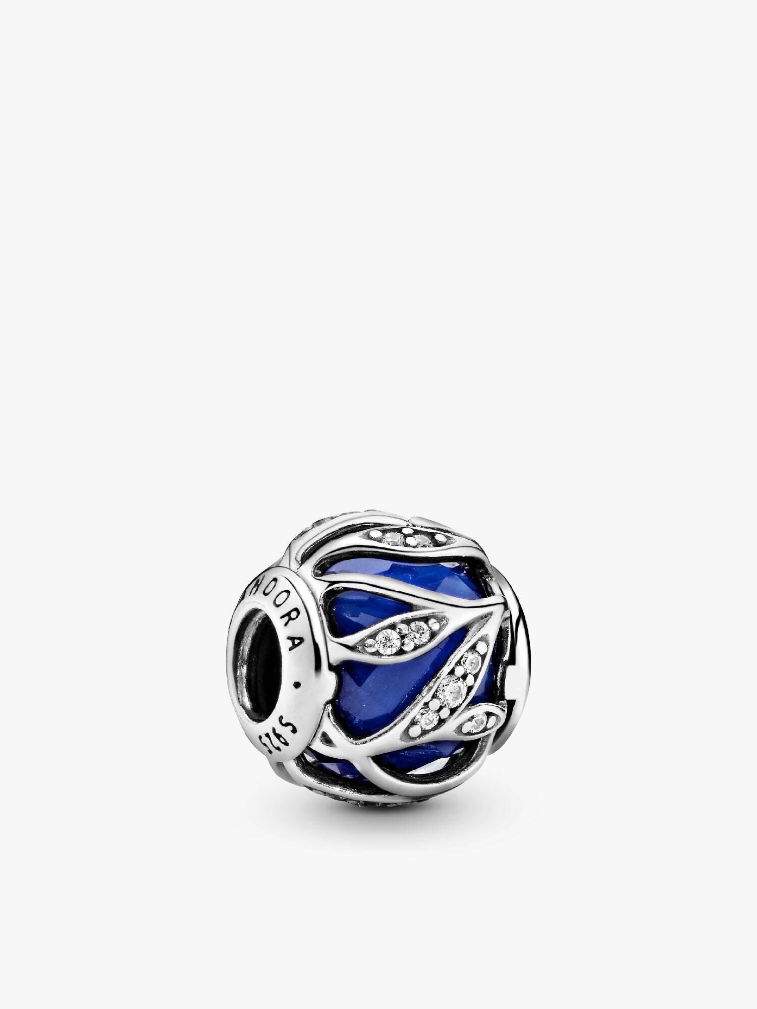 Abstract silver charm with faceted royal blue crystal and clear cubic zirconia