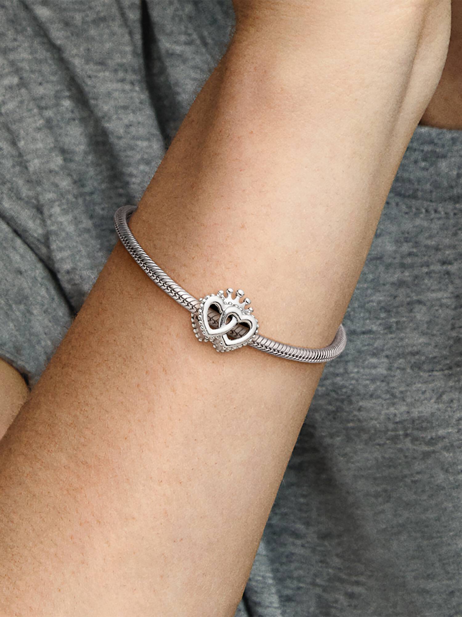 Interlocked crowned hearts silver charm